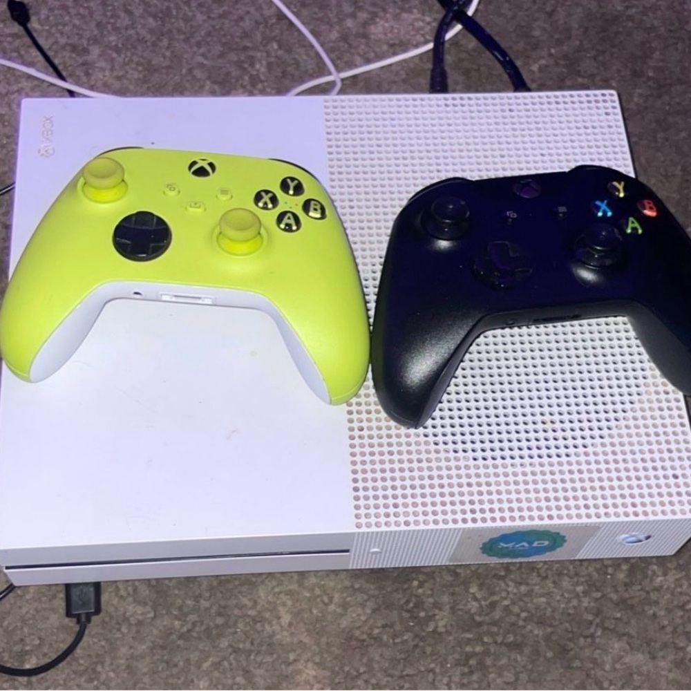 Microsoft Console with White, Yellow, and Black Controllers